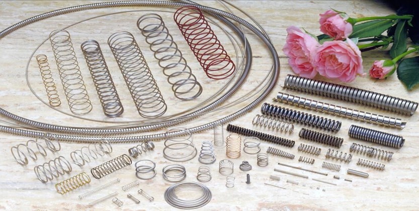 Coiled springs and wire forms laid out for inspection