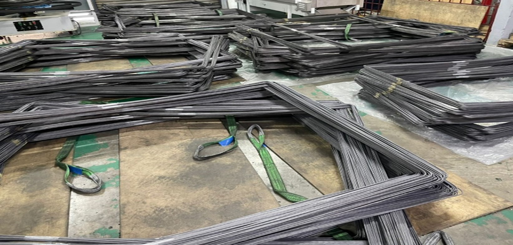 Bundled mattress border wire frames on the production floor in Klang